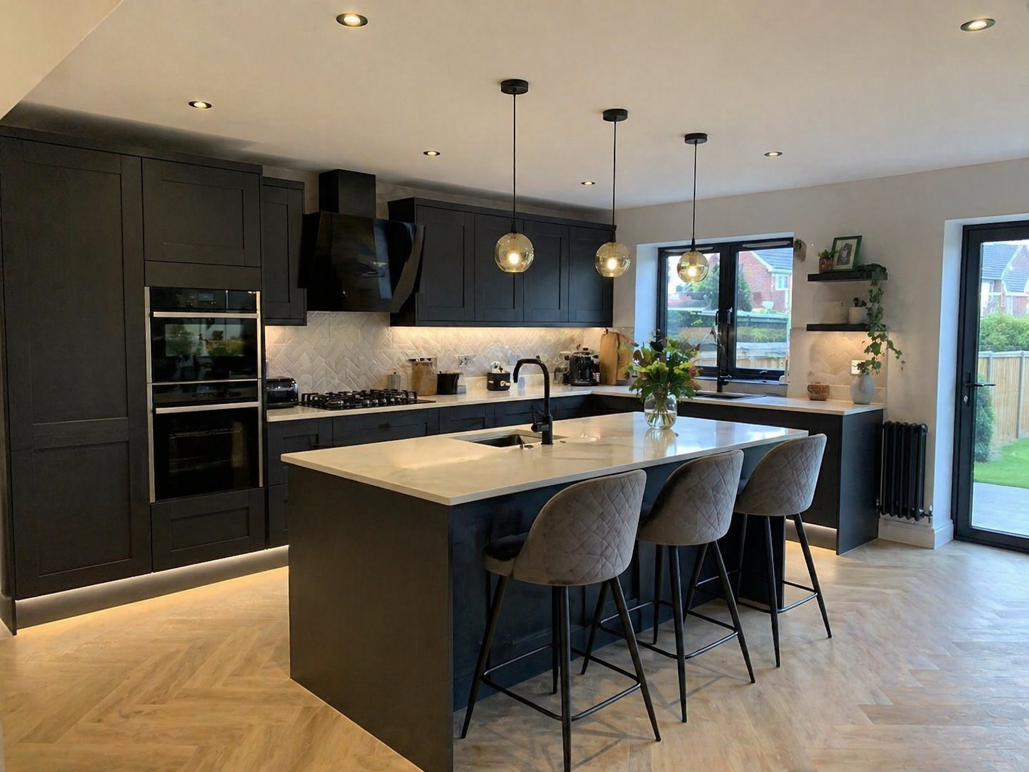 Open-plan kitchen with island and pendant lighting